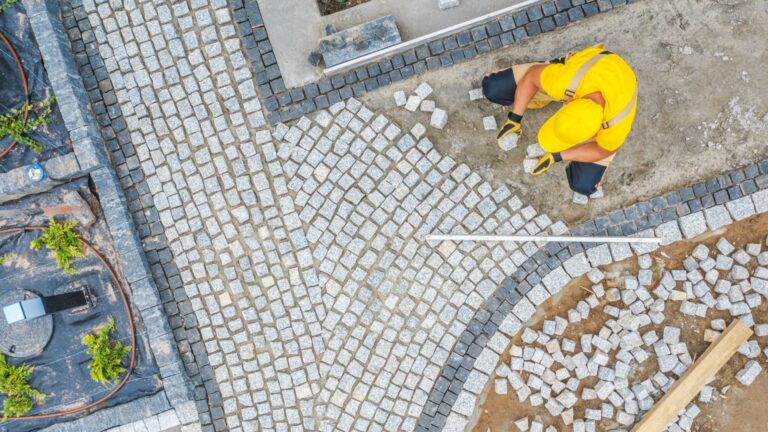 man installs rock garden path