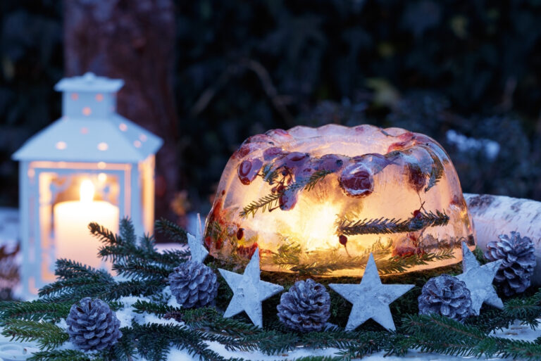 christmas decoration with ice lantern, pine cones and wooden stars (featured image)