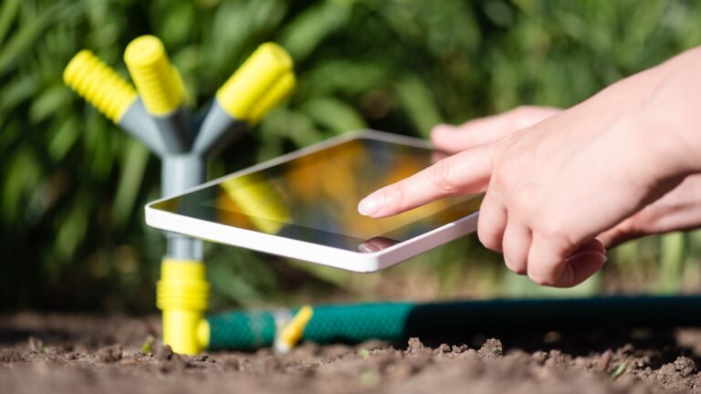 gardener sets up a smart irrigation system