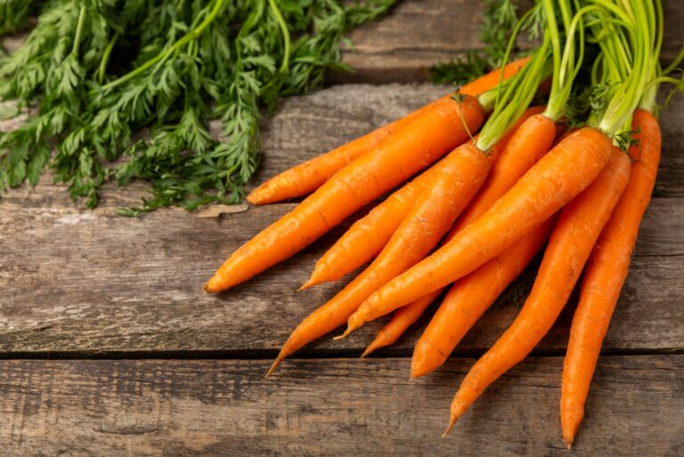 Carrots on a textured wooden background