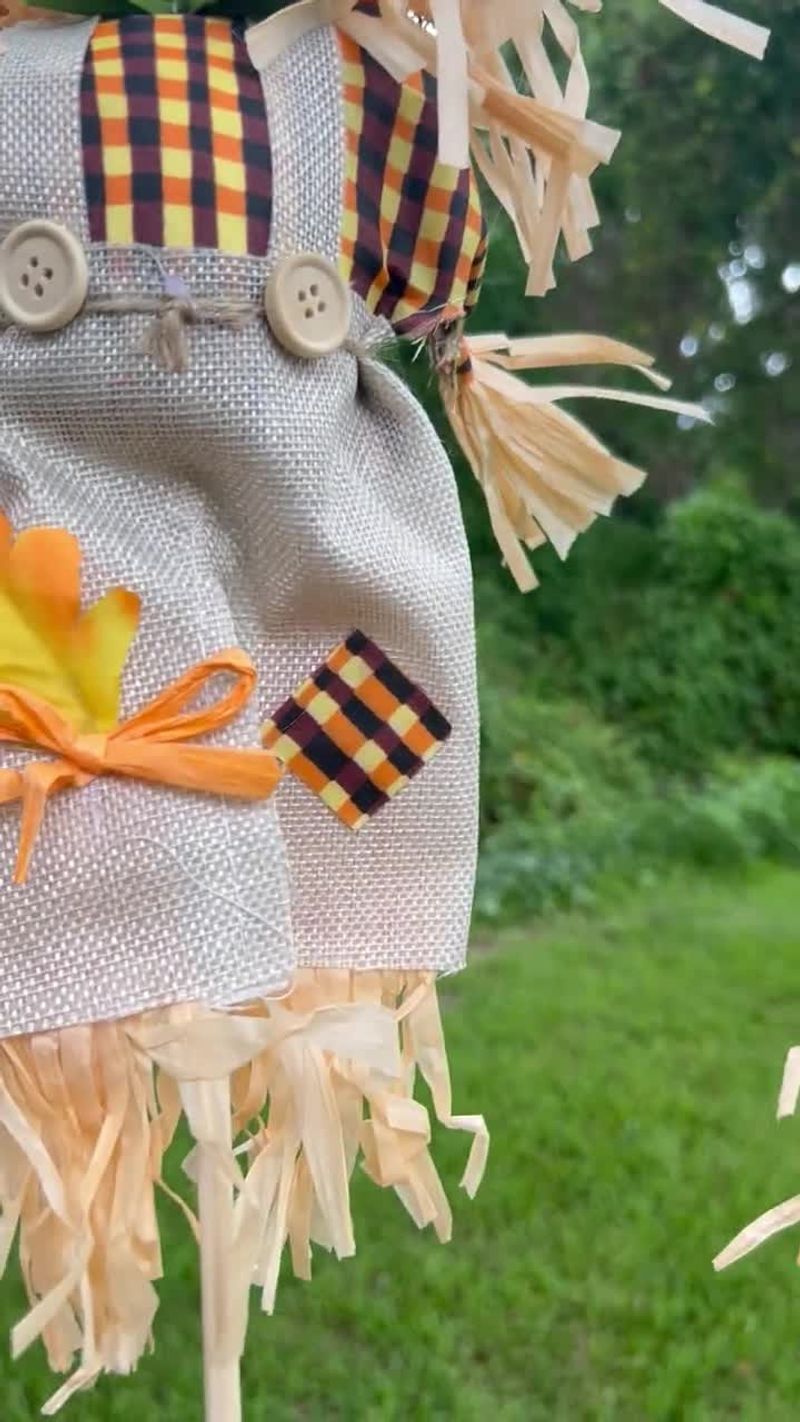 Fabric Scarecrows Near Shrubs