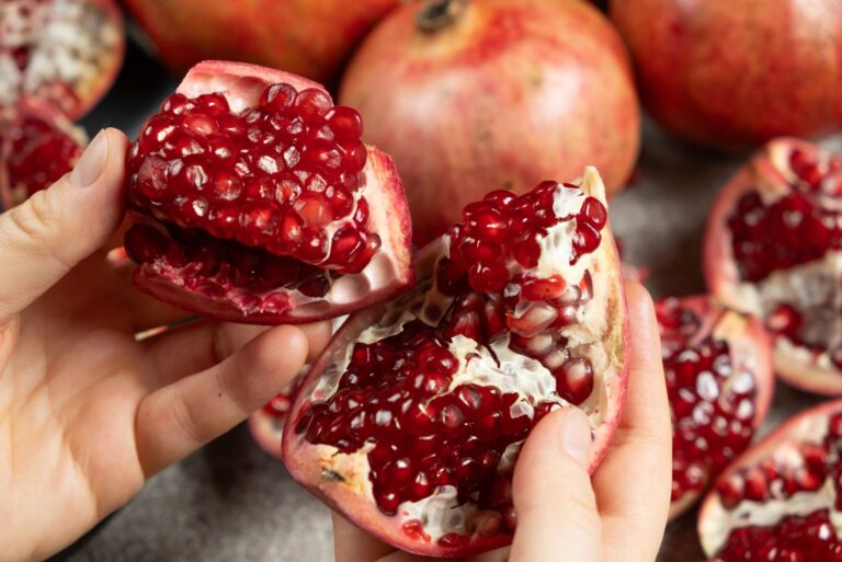 Hands open the pomegranate