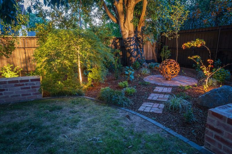 Using Evergreens Hardscaping And Lighting For Year Round Comfort