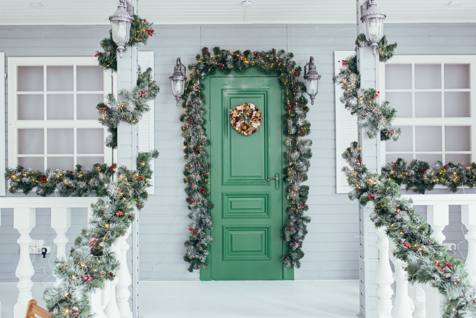 Green door entrance to the house decorated for christmas