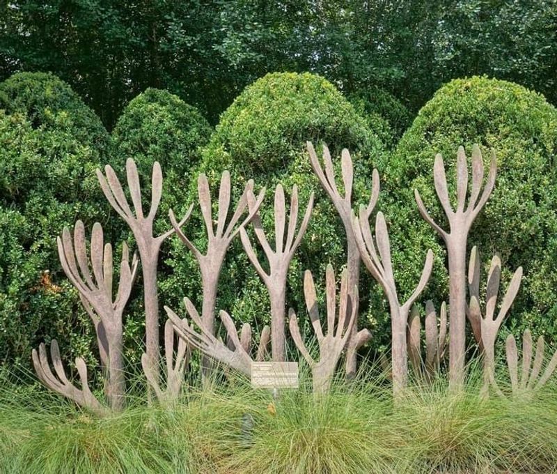 A Large Scale Outdoor Art Exhibit Set In A Natural Garden Landscape