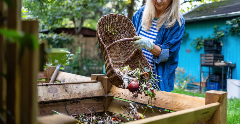 woman composting in garden
