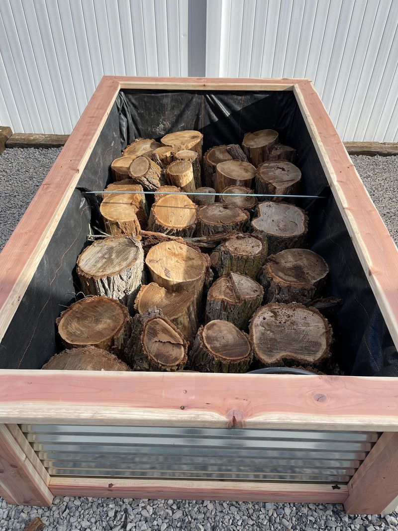 Add Untreated Logs To Reduce Soil Cost And Retain Moisture