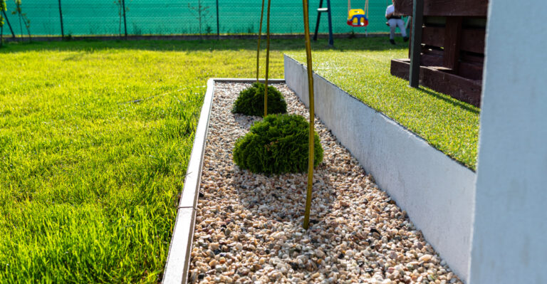 Gravel path separating a lush green lawn