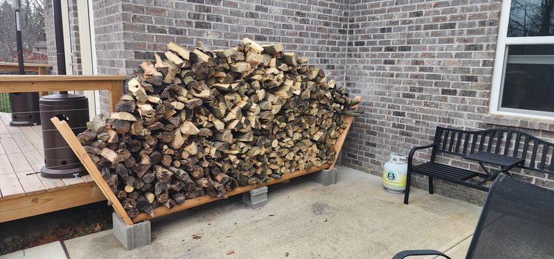 Stacking Firewood Against The House