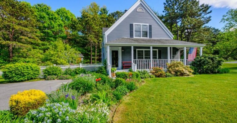 house with a beautiful front yard filled with driveway ornamentals and green lawn